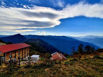 Houses and buildings on mountain against sky