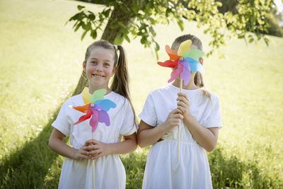 Portrait of siblings playing with balloons