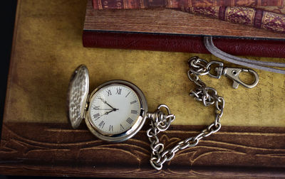 Close-up of pocket watch on table