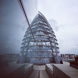 View of modern buildings against cloudy sky