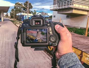 Midsection of woman photographing at camera