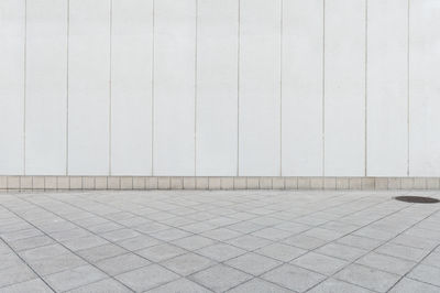 Footpath against white wall