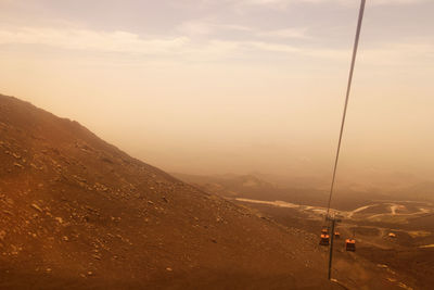 High angle view of overhead cable cars against landscape