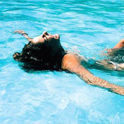 Young woman swimming in pool