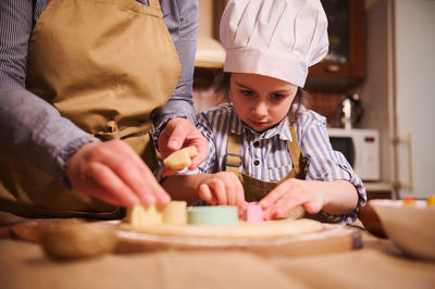 Portrait of cute girl preparing food at home