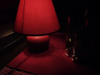 Close-up of illuminated lamp on table