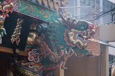 Low angle view of statue against temple building