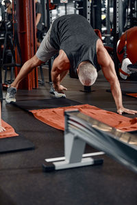Low section of man exercising in gym