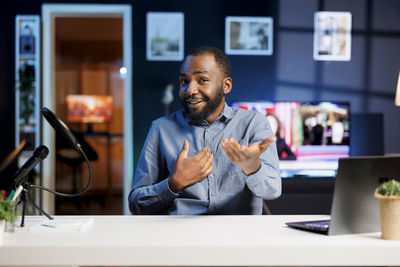 Portrait of young man working at table