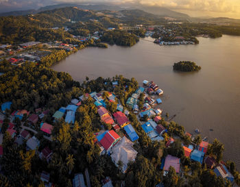 High angle view of city by sea against sky