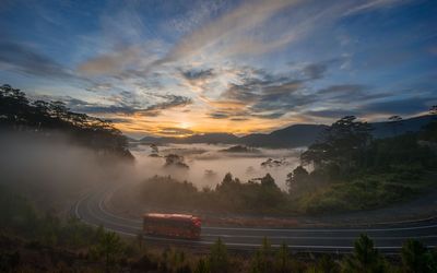 High angle view of bus on road against landscape and sky during sunset