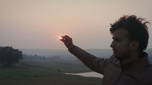 Man against clear sky during sunset