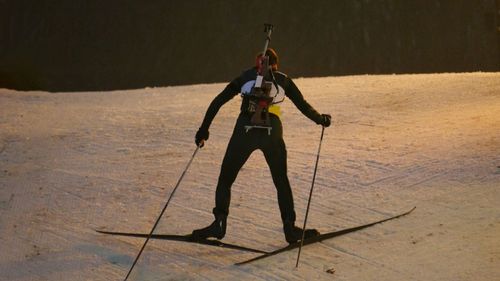 Biathlete on the way to top of the hill