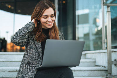 Young woman using laptop at office