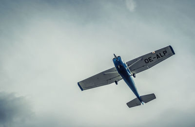 Low angle view of airplane flying against sky