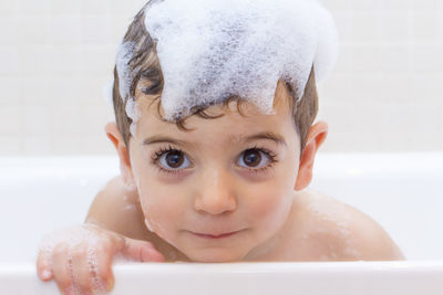 Portrait of baby boy in bathroom