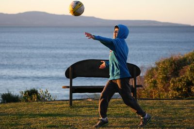 Man playing with ball in water