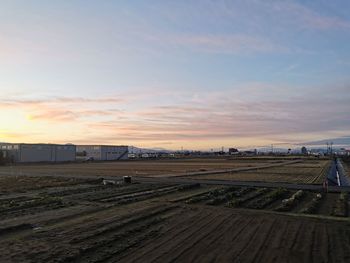 High angle view of field against sky during sunset