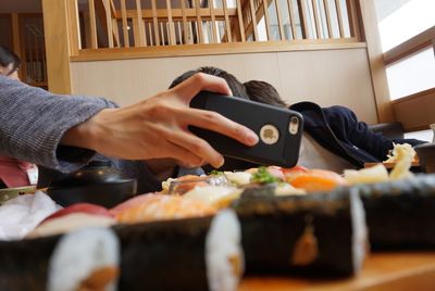 Midsection of man using mobile phone