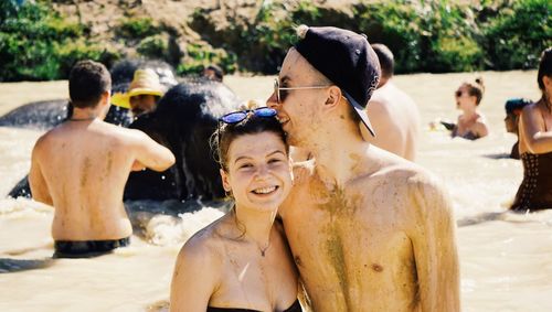 Portrait of smiling man with girlfriend in lake