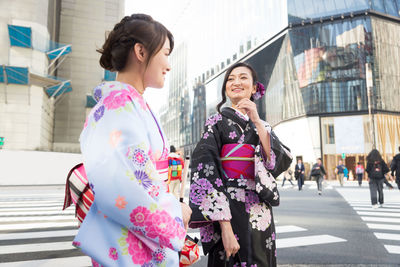 Women walking on street in city