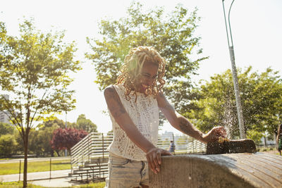 A young woman at a water fountain