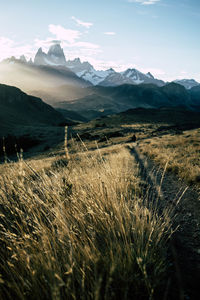 Scenic view of snowcapped mountain peak against sunset sky