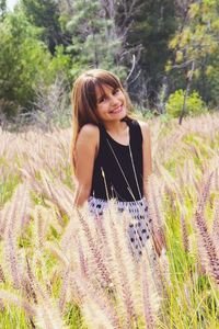 Portrait of smiling young woman on field