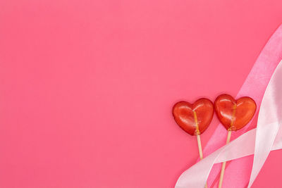 Close-up of heart shape against pink background