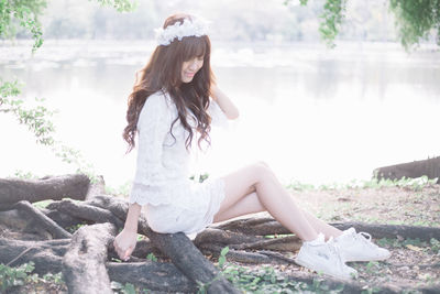 Woman sitting at lakeshore