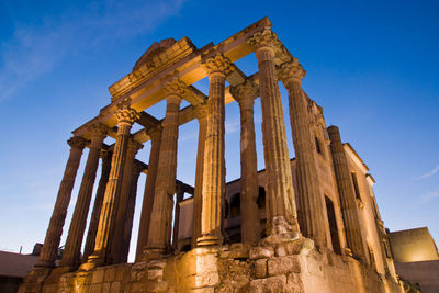 Low angle view of old temple against blue sky