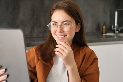 Portrait of young woman using mobile phone