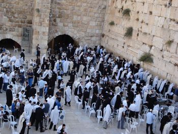 High angle view of people praying by western wall