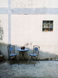 Empty chairs and tables in yard