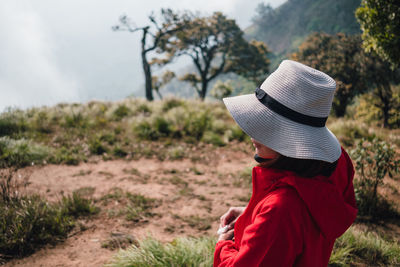 Side view of woman wearing hat