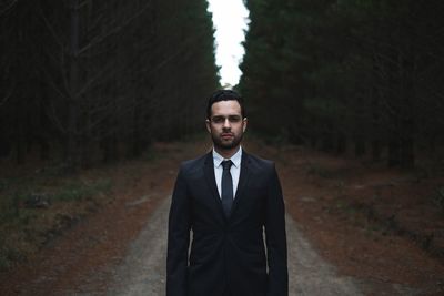 Man wearing suit in forest