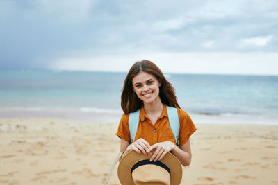 Portrait of smiling young woman on beach