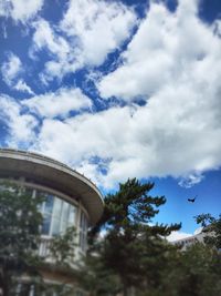 Low angle view of building against cloudy sky