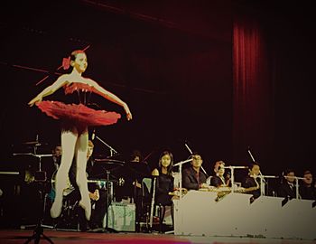 Portrait of young woman sitting on stage