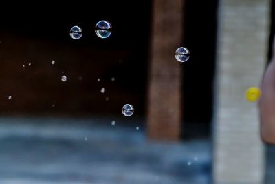 Close-up of bubbles against water