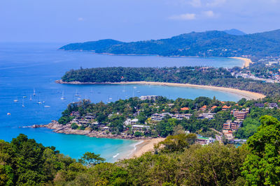 High angle view of sea and cityscape against sky