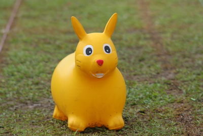 Close-up of yellow toy on field