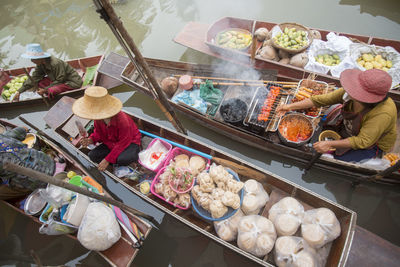 Vendors selling food at floating market