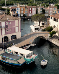 Boats moored on river in town