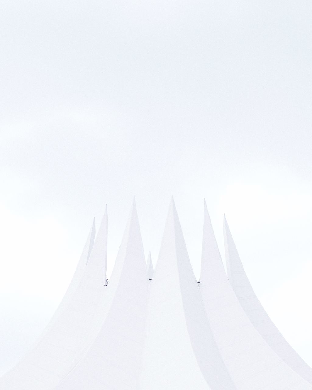 copy space, sky, no people, white color, low angle view, day, nature, clear sky, pattern, architecture, outdoors, studio shot, tent, white, design, built structure, shape, mode of transportation, high section