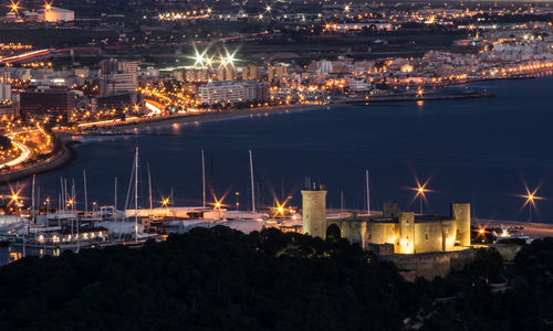 High angle view of illuminated buildings in city at night