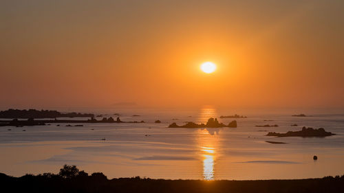Scenic view of sea against romantic sky at sunset