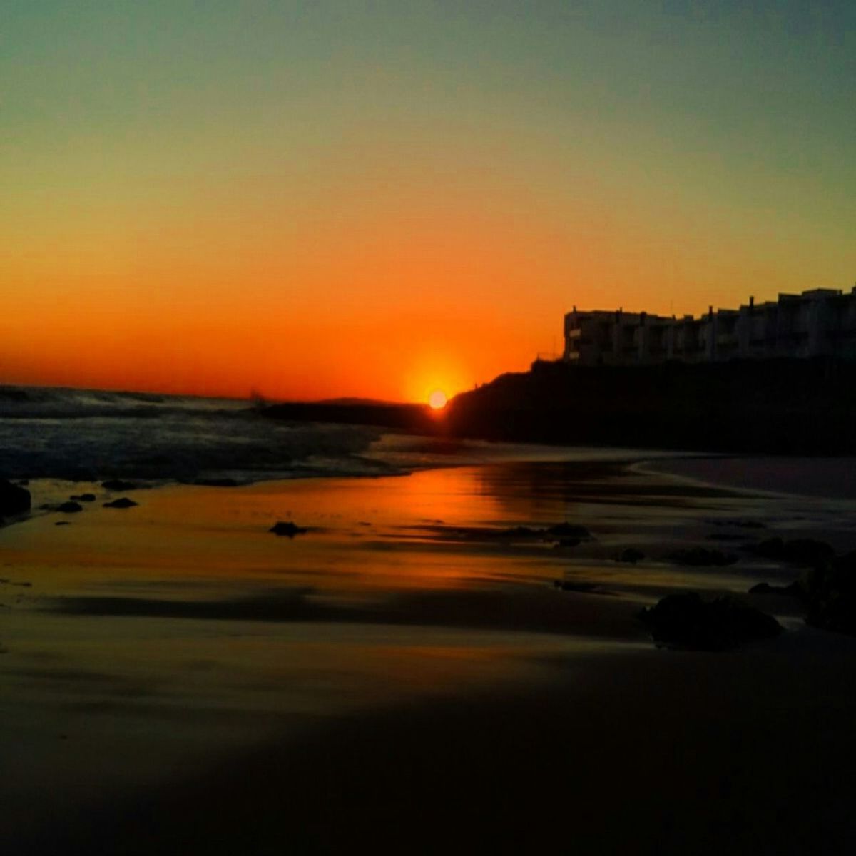 SCENIC VIEW OF BEACH AGAINST SKY DURING SUNSET