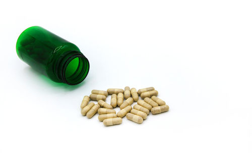 Close-up of pills on white background