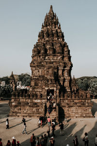 Group of people in temple against clear sky